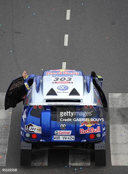 Spainish driver Carlos Sainz and co-driver Lucas Cruz's Volkswagen leaves the podium during the presentation of the Dakar 2010 on Januray 1, 2010 in...