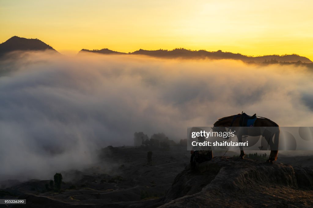 Silhouette of unidentified local people or Bromo Horseman at the mountainside of Mount Bromo, Semeru, Tengger National Park, Indonesia.