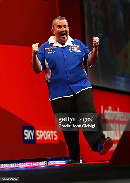 Phil Taylor of England celebrates winning his game against Adrian Lewis of England during the Quarter Finals of the 2010 Ladbrokes.com World Darts...
