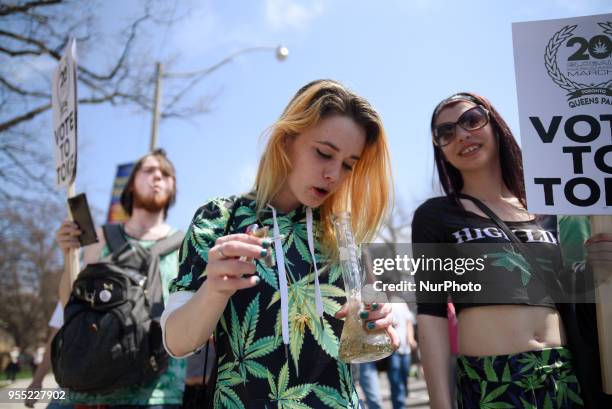 Teens smoking up Marijuana with a bong during the Toronto Global Marijuana march 2018, just a few months before Canada legalizes Marijuana in...