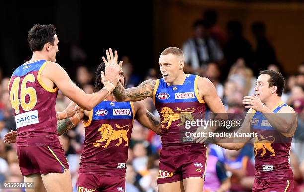 Mitch Robinson of the Lions celebrates scoring a goal during the round seven AFL match between the Brisbane Lions and the Collingwood Magpies at The...