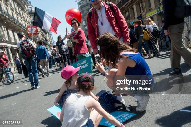 People take part in a protest dubbed a 'Party for Macron' against the policies of the French president on the first anniversary of his election, on...