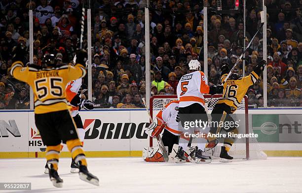 Marco Sturm and Johnny Boychuk of the Boston Bruins celebrate after Sturm scored the game-winning goal in overtime to win 2-1 against goalie Michael...