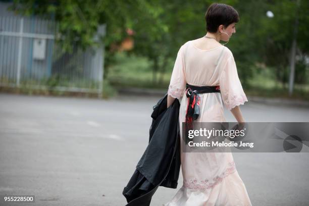 Kato Gogashvili wears her grandmother's vintage tan nightgown with a belt and black boots on May 5, 2018 in Tbilisi, Georgia.