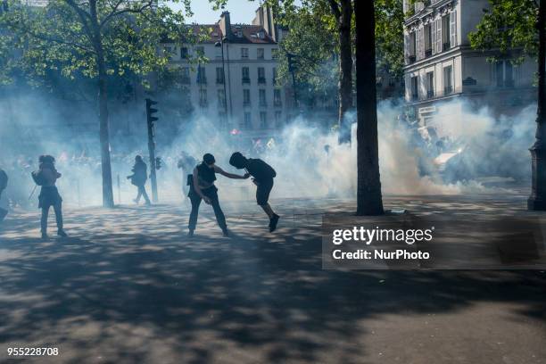 People take part in a protest dubbed a 'Party for Macron' against the policies of the French president on the first anniversary of his election, on...