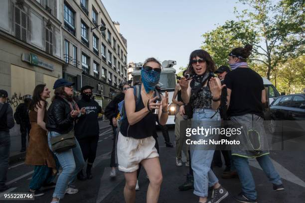 People take part in a protest dubbed a 'Party for Macron' against the policies of the French president on the first anniversary of his election, on...