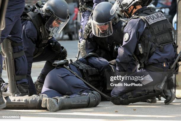 French police officer lies injured on the ground as thousands gathered during a protest dubbed a &quot;Party for Macron&quot; against the policies of...