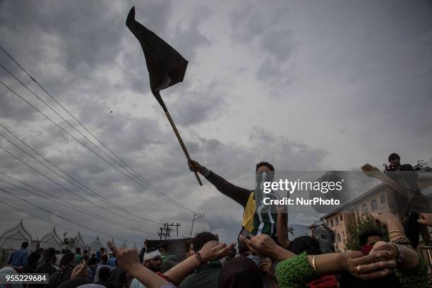 Kashmiri Muslim protesters raise anti-India slogans during the funeral procession of a civilian Adil Ahmed, Saturday, May 5 in Srinagar,...