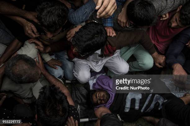 Kashmiri Muslims carry the body of Adil Ahmad, a civilian who was crushed to death by an Indian forces' vehicle, during his funeral procession...