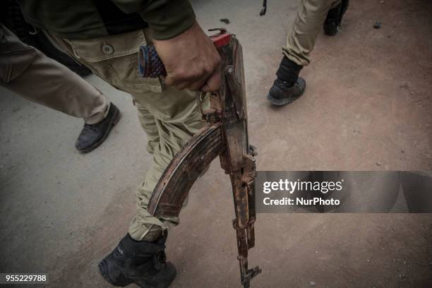 Recovered AK47 gun of the suspected rebel from the gunfight site is taken away by an Indan policeman Saturday, May 5 in Srinagar, Indian-controlled...