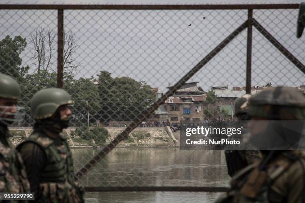 Kashmiri youth protest across the river near the gunfight site Saturday, May 5 in Srinagar, Indian-controlled Kashmir. Three rebels were killed in a...