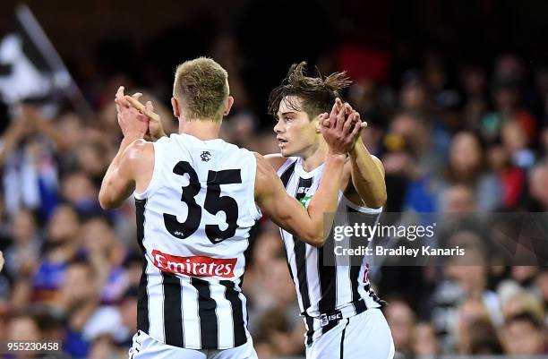 Josh Thomas of Collingwood celebrates scoring a goal during the round seven AFL match between the Brisbane Lions and the Collingwood Magpies at The...