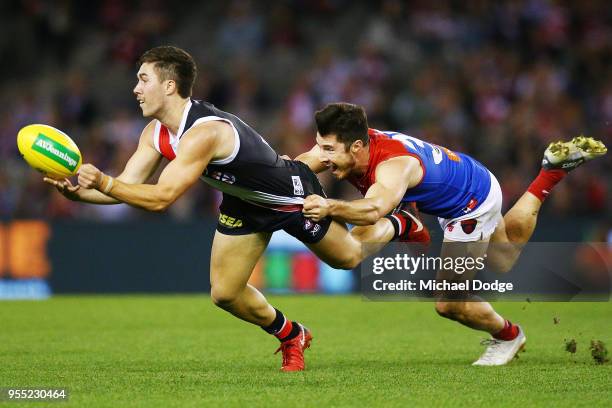 Alex Neal-Bullen of the Demons tackles Jade Gresham of the Saints during the round seven AFL match between St Kilda Saints and the Melbourne Demons...