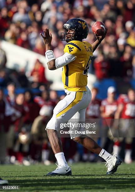 Quarterback Geno Smith of the West Virginia Mountaineers throws a pass against the Florida State Seminoles during the Konica Minolta Gator Bowl on...