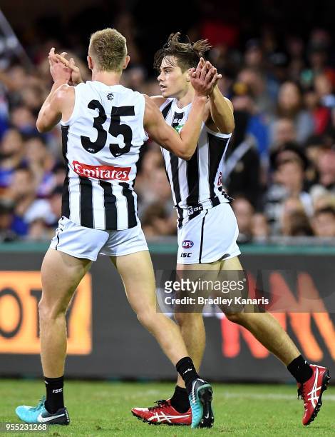 Josh Thomas of Collingwood celebrates scoring a goal during the round seven AFL match between the Brisbane Lions and the Collingwood Magpies at The...