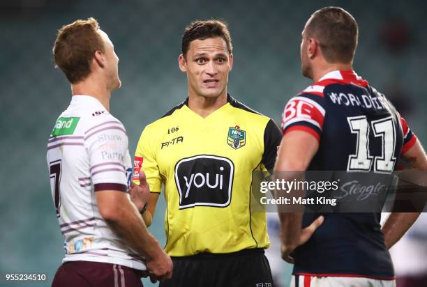 Referee Henry Perenara speaks to Sea Eagles captain Daly Cherry-Evans and Roosters captain Boyd Cordner during the round nine NRL match between the...