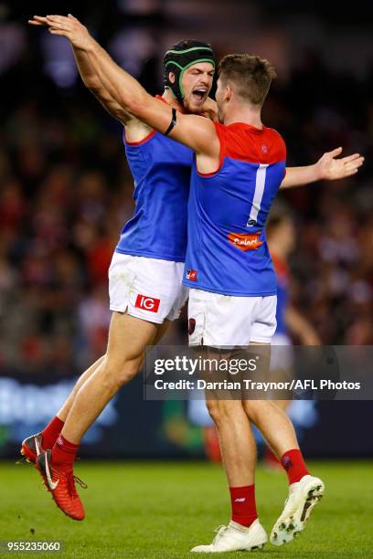 Angus Brayshaw and Jesse Hogan of the Demons celebrate a goal during the round seven AFL match between St Kilda Saints and the Melbourne Demons at...