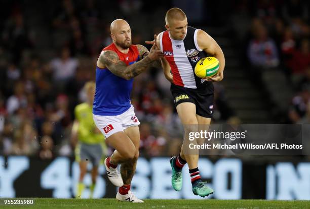 Sebastian Ross of the Saints is tackled by Nathan Jones of the Demons during the 2018 AFL round seven match between the St Kilda Saints and the...