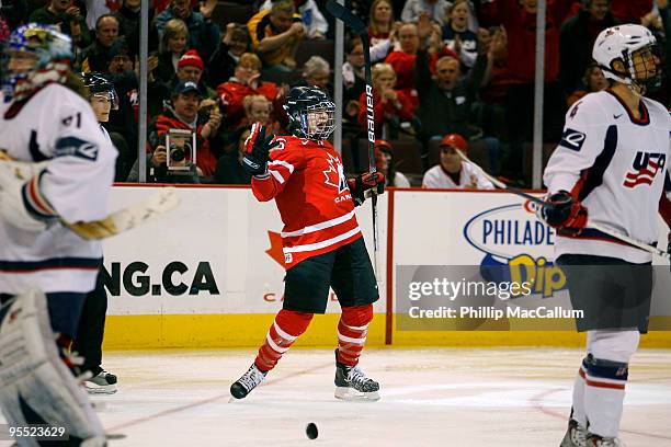 Sarah Vaillancourt of Team Canada celebrates her goal while Jessie Vetter and Angela Ruggiero of Team USA look away dejectledly in a game at...