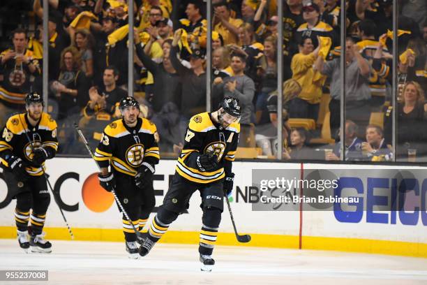 Patrice Bergeron, Brad Marchand and David Pastrnak of the Boston Bruins celebrate a goal against the Tampa Bay Lightning in Game Four of the Eastern...