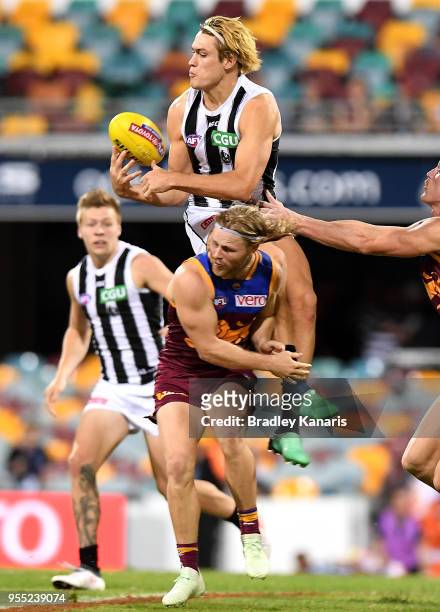 Darcy Moore of Collingwood competes for the mark during the round seven AFL match between the Brisbane Lions and the Collingwood Magpies at The Gabba...