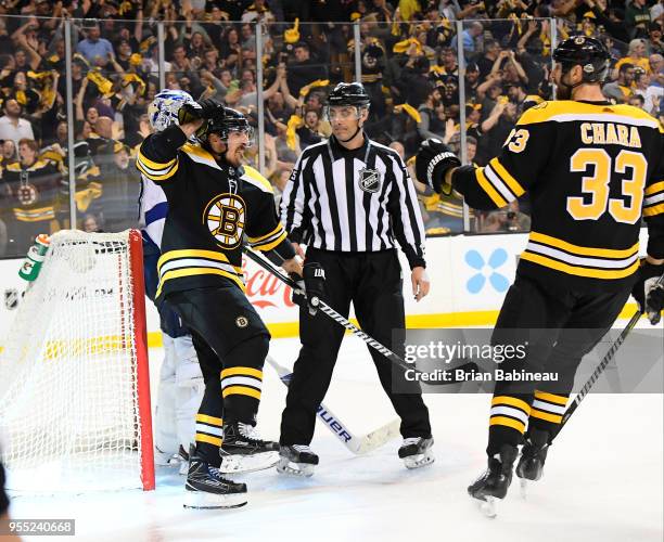 Brad Marchand and Zdeno Chara of the Boston Bruins celebrate a goal against the Tampa Bay Lightning in Game Four of the Eastern Conference Second...