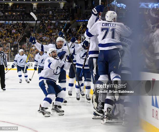 Anthony Cirelli of the Tampa Bay Lightning celebrates the overtime goal against the Boston Bruins with his teammates in Game Four of the Eastern...