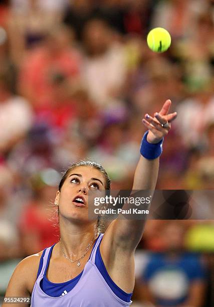 Sorena Cirstea of Romania serves in her match against Samantha Stosur of Australia in the Group A match between Australia and Romania during day one...