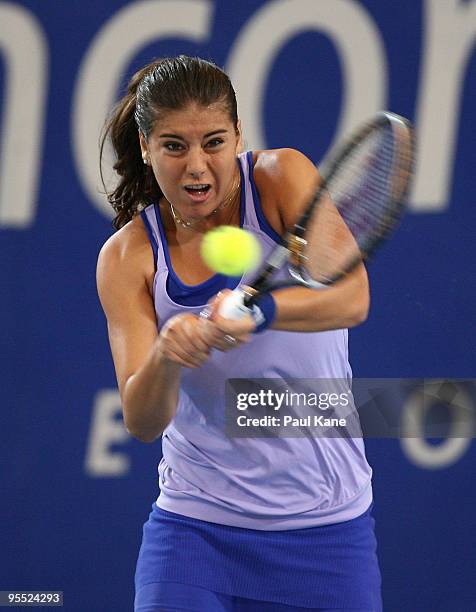 Sorena Cirstea of Romania plays a backhand in her match against Samantha Stosur of Australia in the Group A match between Australia and Romania...