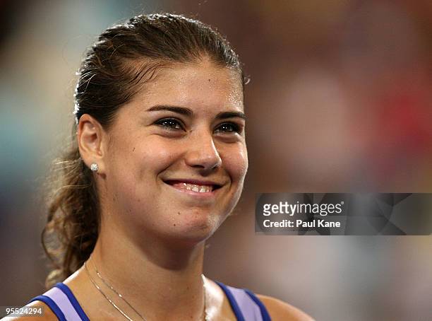 Sorena Cirstea of Romania smiles after defeating Samantha Stosur of Australia in the Group A match between Australia and Romania during day one of...