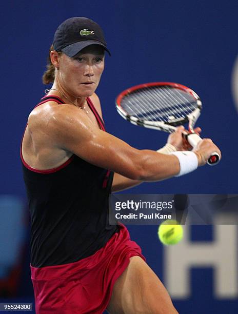 Samantha Stosur of Australia plays a backhand in her match against Sorena Cirstea of Romania in the Group A match between Australia and Romania...