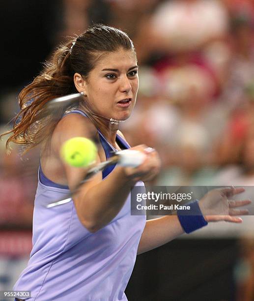 Sorena Cirstea of Romania plays a forehand in her match against Samantha Stosur of Australia in the Group A match between Australia and Romania...