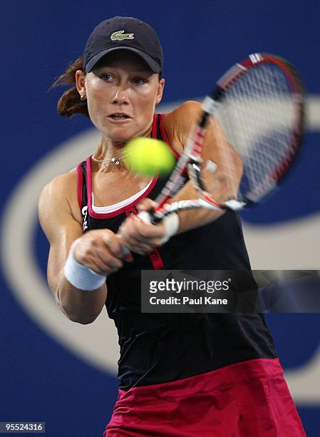 Samantha Stosur of Australia plays a backhand in her match against Sorena Cirstea of Romania in the Group A match between Australia and Romania...