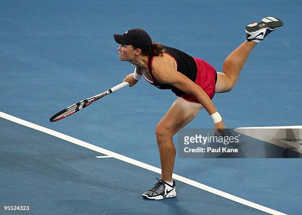 Samantha Stosur of Australia serves in her match against Sorena Cirstea of Romania in the Group A match between Australia and Romania during day one...