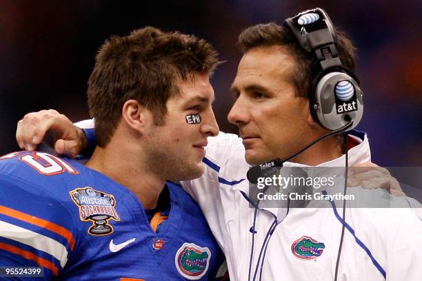 Tim Tebow of the Florida Gators hugs his head coach Urban Meyer after scoring a touchdown against the Cincinnati Bearcats during the Allstate Sugar...