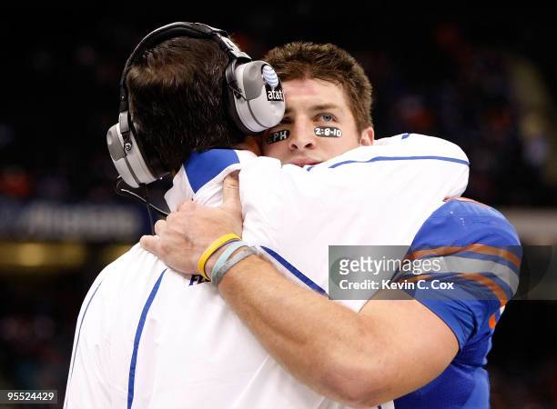 Tim Tebow of the Florida Gators hugs his head coach Urban Meyer after scoring a touchdown against the Cincinnati Bearcats during the Allstate Sugar...