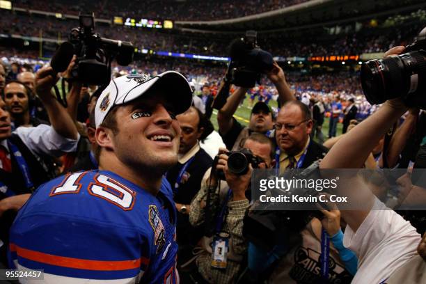 Tim Tebow of the Florida Gators walks off the field after defeating the Bearcats 24-51 in the Allstate Sugar Bowl at the Louisana Superdome on...
