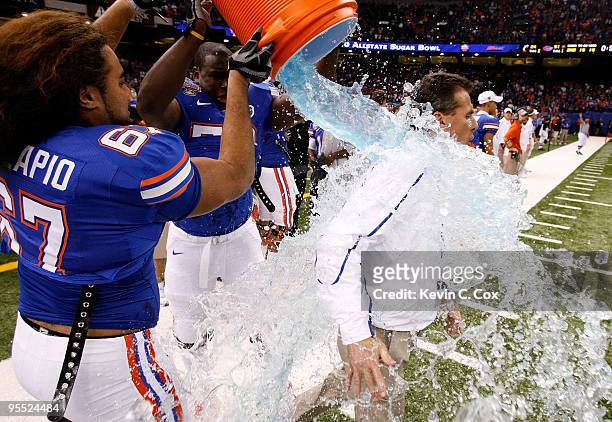 Head coach Urban Meyer gets sports drink dumped on him by Jon Halapio of the Florida Gators after the Gators defeated the Bearcats 24-51 in the...