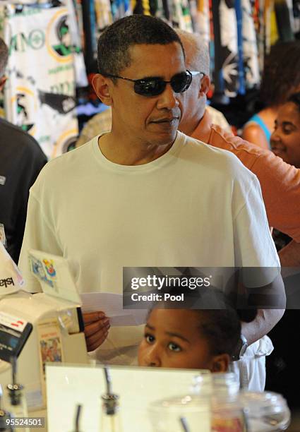 President Barack Obama gets snocones with his daughter Sasha and family friends at Island Snow on January 1, 2010 in Kailua, Hawaii. Obama and his...