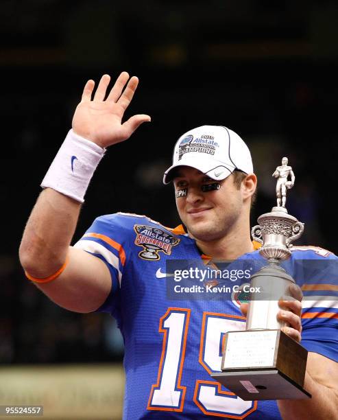 Tim Tebow of the Florida Gators hoist a trophy after defeating the Cincinnati Bearcats 24-51 in the Allstate Sugar Bowl at the Louisana Superdome on...