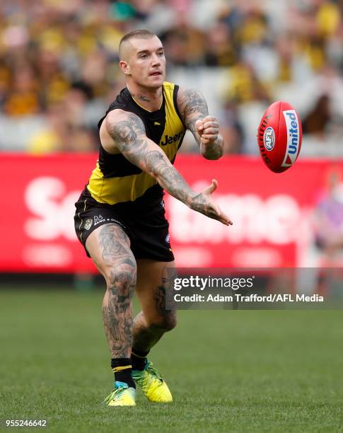 Dustin Martin of the Tigers handpasses the ball during the 2018 AFL round seven match between the Richmond Tigers and the Fremantle Dockers at the...