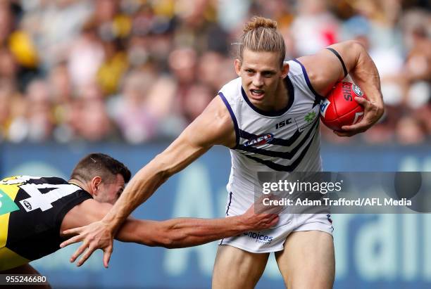 Nat Fyfe of the Dockers is tackled by Jack Graham of the Tigers during the 2018 AFL round seven match between the Richmond Tigers and the Fremantle...