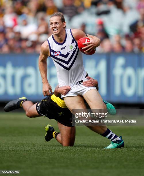 Nat Fyfe of the Dockers is tackled by Jack Graham of the Tigers during the 2018 AFL round seven match between the Richmond Tigers and the Fremantle...