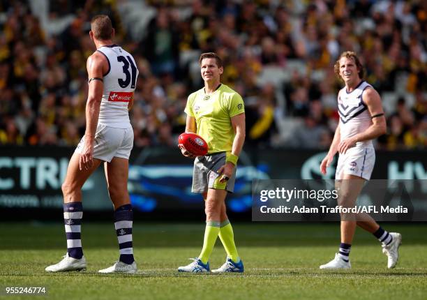 Umpire Simon Meredith looks on during a score review during the 2018 AFL round seven match between the Richmond Tigers and the Fremantle Dockers at...