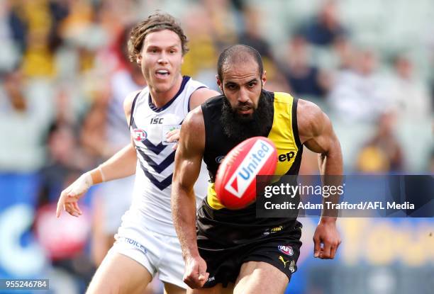 Bachar Houli of the Tigers in action in his 150th game ahead of Ed Langdon of the Dockers during the 2018 AFL round seven match between the Richmond...