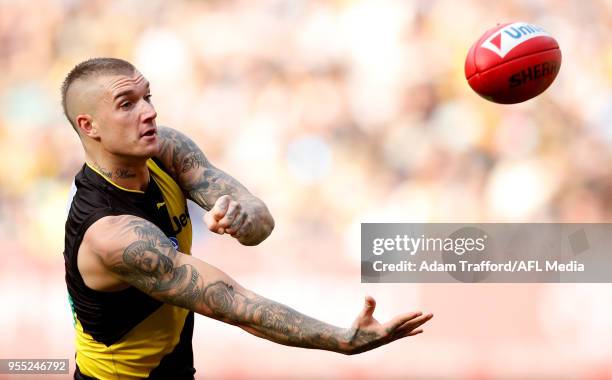 Dustin Martin of the Tigers handpasses the ball during the 2018 AFL round seven match between the Richmond Tigers and the Fremantle Dockers at the...