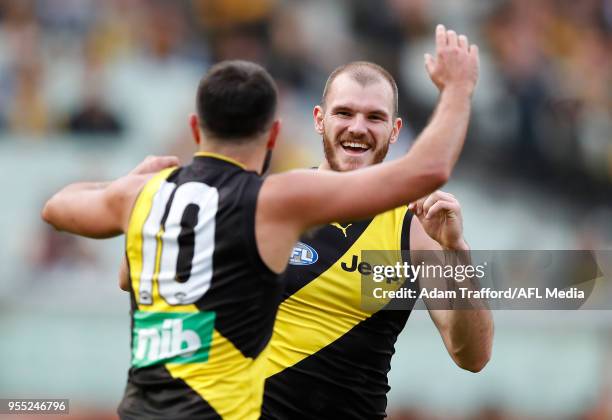 Kamdyn McIntosh of the Tigers celebrates a goal with Shane Edwards of the Tigers during the 2018 AFL round seven match between the Richmond Tigers...