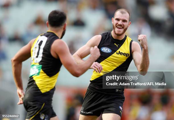 Kamdyn McIntosh of the Tigers celebrates a goal with Shane Edwards of the Tigers during the 2018 AFL round seven match between the Richmond Tigers...