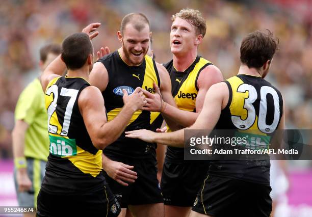 Kamdyn McIntosh of the Tigers celebrates a goal L-R Sam Lloyd, Josh Caddy and Reece Conca of the Tigers during the 2018 AFL round seven match between...