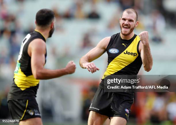 Kamdyn McIntosh of the Tigers celebrates a goal with Shane Edwards of the Tigers during the 2018 AFL round seven match between the Richmond Tigers...